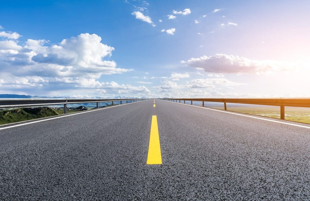 An empty road with blue sky in the background