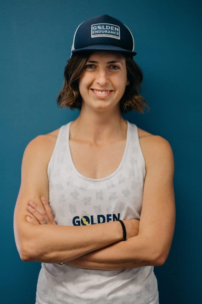 sammie smiling wearing a ball cap that says golden endurance and a tank top