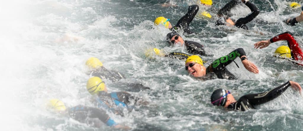 people swimming in an open water competition