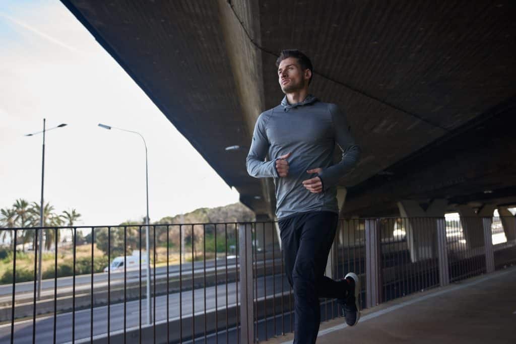 A person running under a bridge