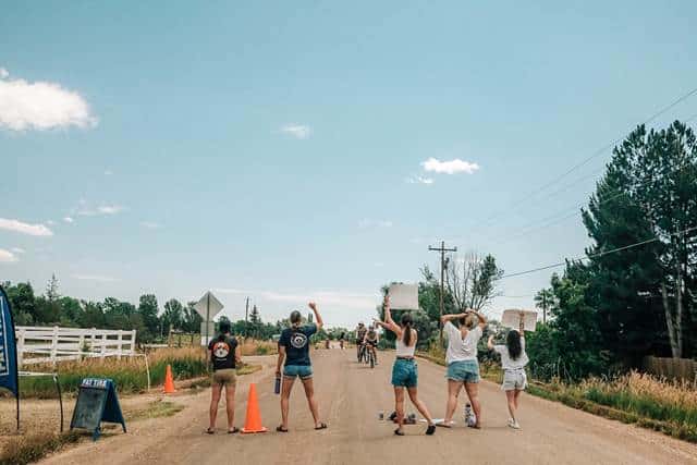People holding signs at a cycling race