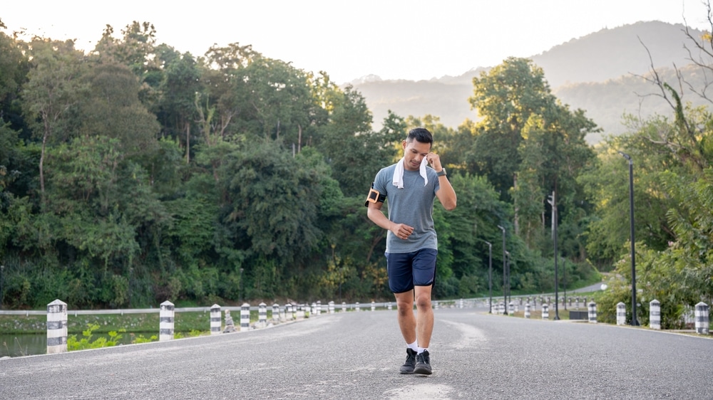 Runner wiping sweat